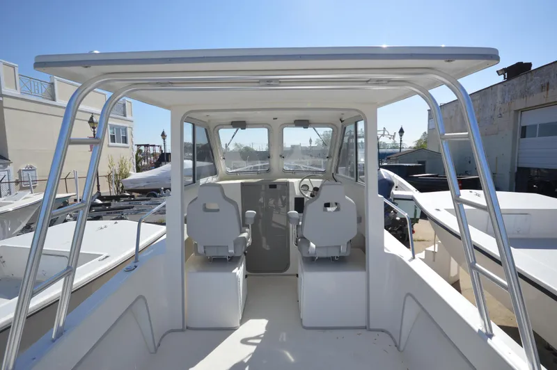 Slide: The Image of 2023 May-Craft 23 Pilothouse boat interior with dual captain chairs. - 8