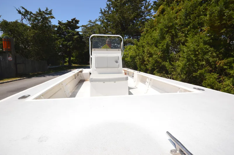 Slide: The Image of 2023 May-Craft 19 HANCOCK boat, white interior, center console, parked near trees. - 6