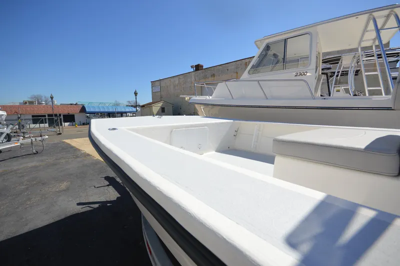 Slide: The Image of 2023 May-Craft 22 HANCOCK boat docked, showcasing spacious deck and seating. - 1