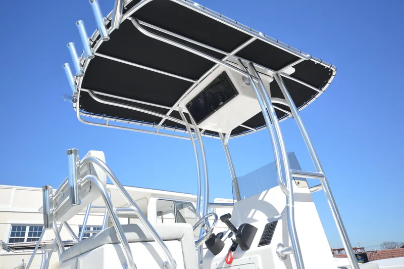 Slide: The Image of 2023 May-Craft 22 HANCOCK boat with T-top and console, clear blue sky background. - 3