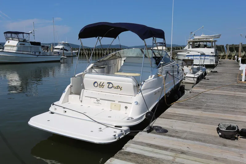 Slide: The Image of 2005 Regal Commodore 2665 boat named "Off Duty" docked at a marina. - 1