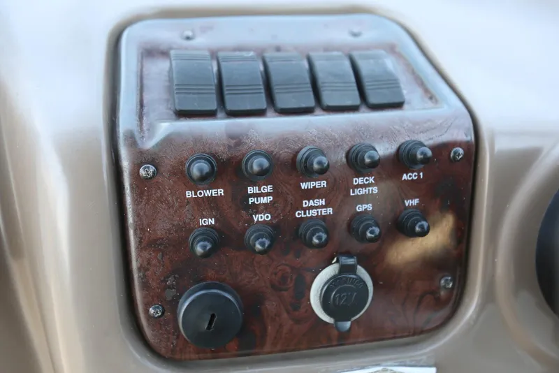 Slide: The Image of Control panel of a 2005 Regal Commodore 2665 boat with various switches and knobs. - 19
