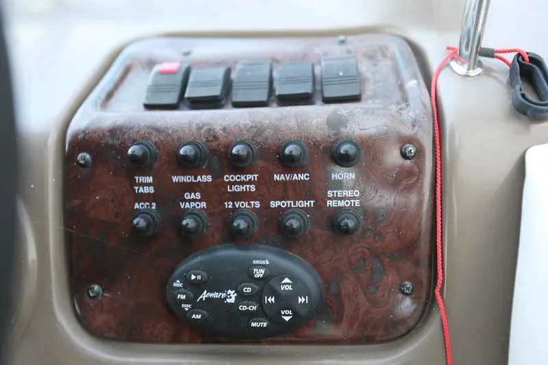 Slide: The Image of Control panel of a 2005 Regal Commodore 2665 boat with various switches and stereo controls. - 20