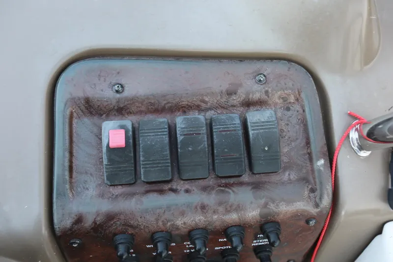Slide: The Image of Control panel of a 2005 Regal Commodore 2665 boat with switches and red lanyard. - 22