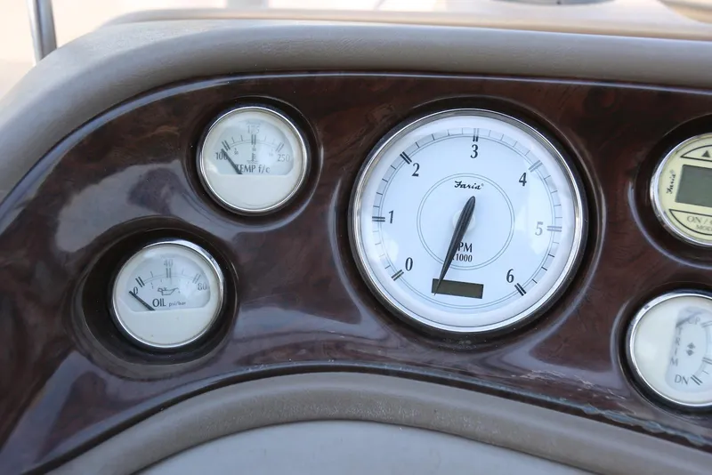 Slide: The Image of Dashboard gauges of a 2005 Regal Commodore 2665 boat, featuring RPM, temperature, and oil indicators. - 23