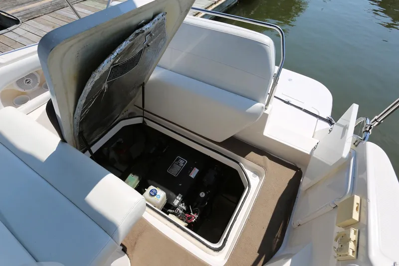 Slide: The Image of Open engine compartment of 2005 Regal Commodore 2665 boat, showing interior details and seating area. - 40