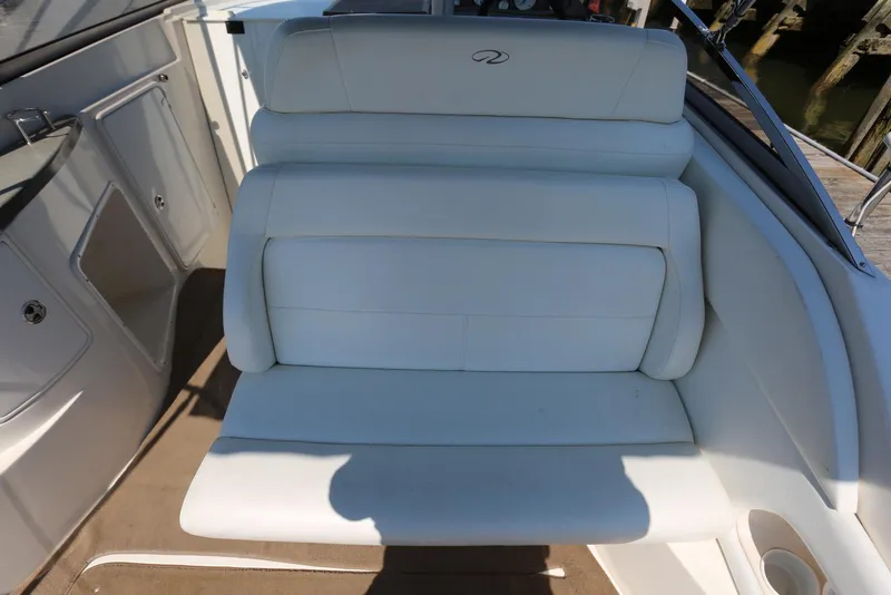 Slide: The Image of 2005 Regal Commodore 2665 boat interior with white cushioned seating. - 42