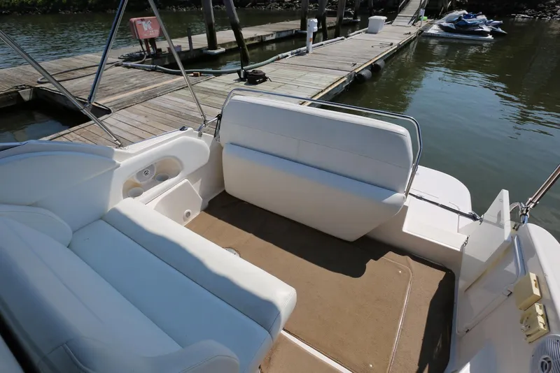 Slide: The Image of 2005 Regal Commodore 2665 boat interior with white seating and dock view. - 46
