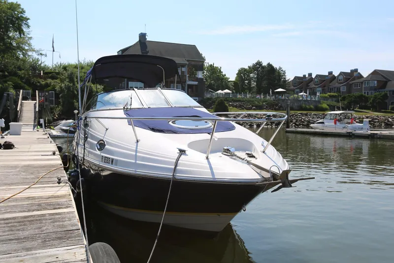 Slide: The Image of 2005 Regal Commodore 2665 boat docked at a marina, surrounded by waterfront homes. - 5
