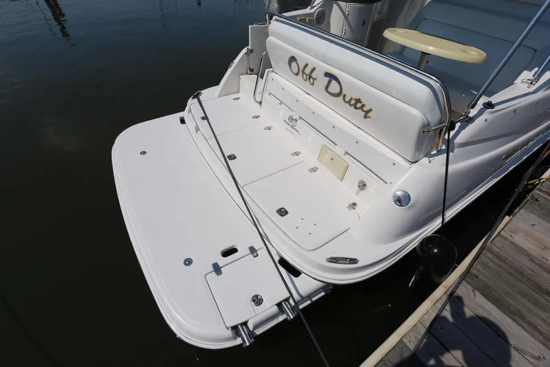 Slide: The Image of 2005 Regal Commodore 2665 boat docked, featuring "Off Duty" on the backrest. - 8