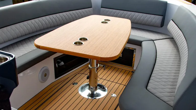 Slide: The Image of 2023 Alfastreet 21 Open boat interior with wooden table and cushioned seating. - 9