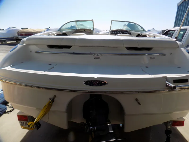 Slide: The Image of 2001 Chaparral 216 SSi boat, rear view, parked on a trailer in a sunny marina. - 10