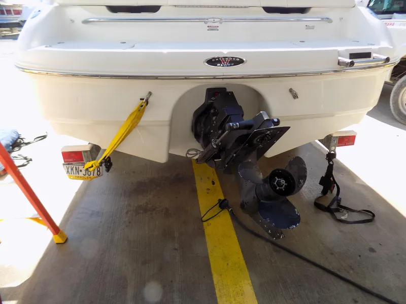 Slide: The Image of Rear view of a 2001 Chaparral 216 SSi boat with visible propeller and license plate. - 11