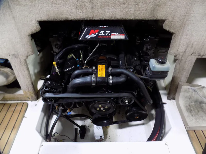 Slide: The Image of Engine compartment of a 2001 Chaparral 216 SSi boat, featuring a 5.7L V8 engine. - 13