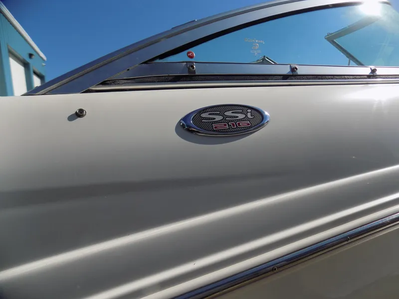 Slide: The Image of 2001 Chaparral 216 SSi boat emblem on white hull under clear blue sky. - 9