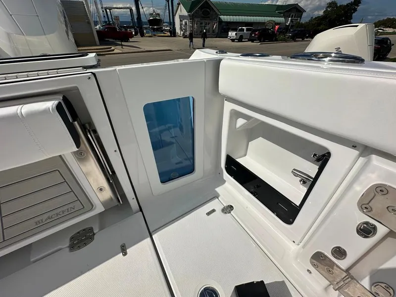 Slide: The Image of 2024 Blackfin 302 DC boat interior with storage compartments and seating. - 11