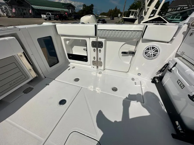Slide: The Image of 2024 Blackfin 302 DC boat interior, featuring storage compartments and a clean, white deck. - 13