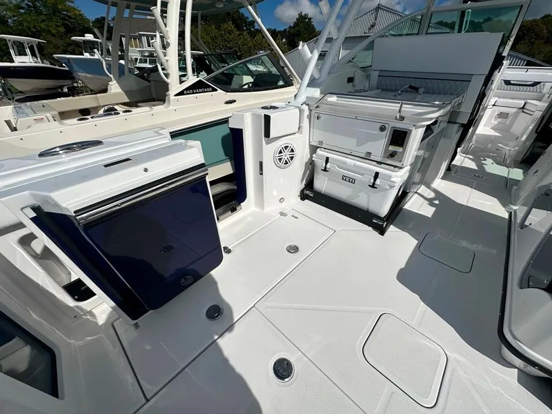 Slide: The Image of 2024 Blackfin 302 DC boat interior with storage compartments and seating. - 14