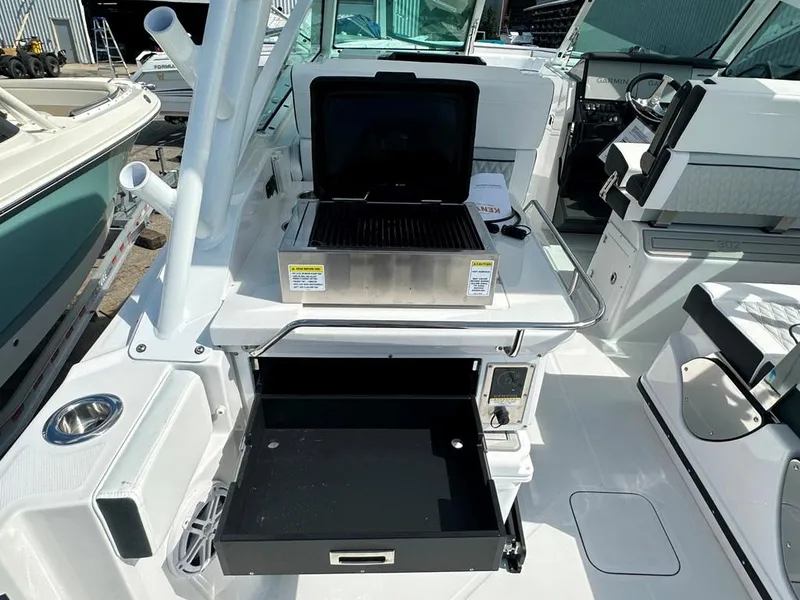 Slide: The Image of 2024 Blackfin 302 DC boat interior with grill and storage compartment. - 16