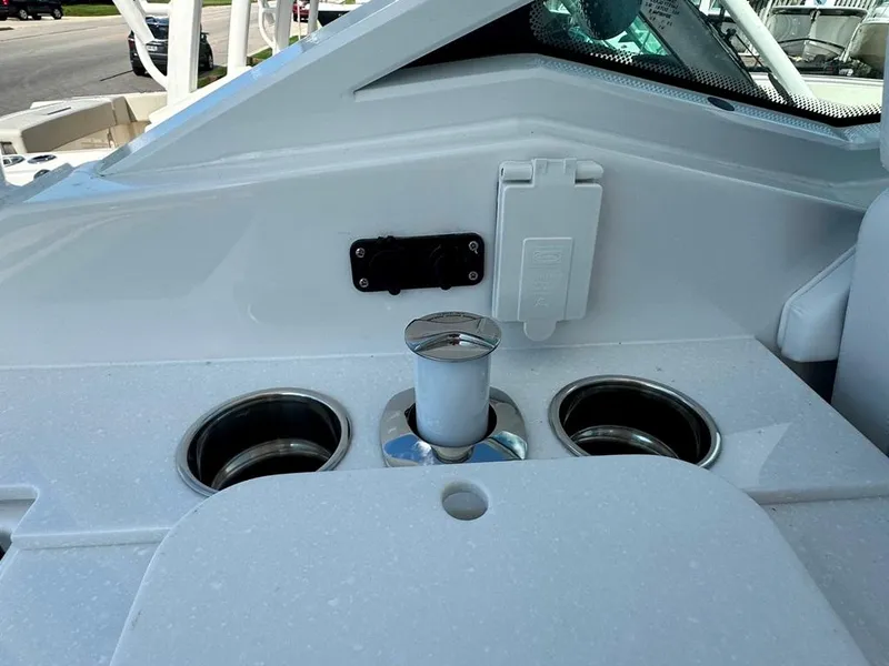 Slide: The Image of 2024 Blackfin 302 DC boat interior with cup holders and a mounted accessory. - 21