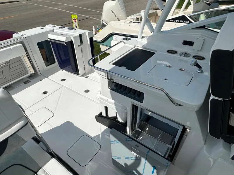 Slide: The Image of 2024 Blackfin 302 DC boat interior with open storage compartments and sink. - 22