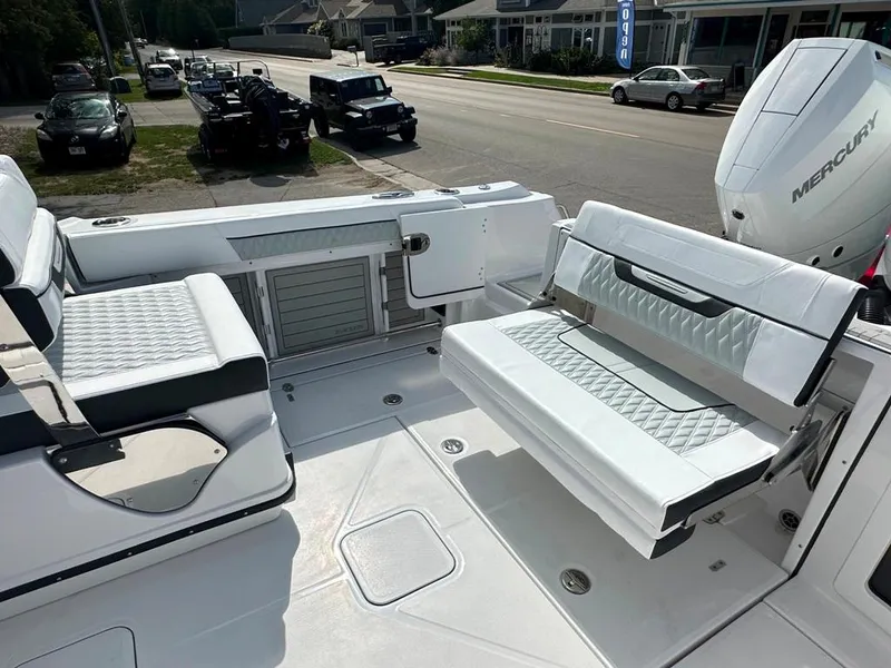 Slide: The Image of 2024 Blackfin 302 DC boat interior with white seating and Mercury outboard motor. - 23