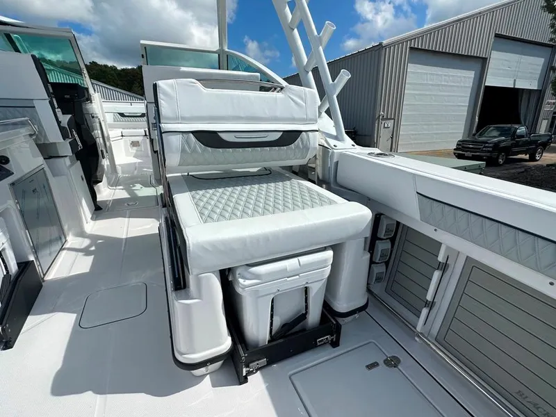 Slide: The Image of 2024 Blackfin 302 DC boat interior with cushioned seating and storage. - 28