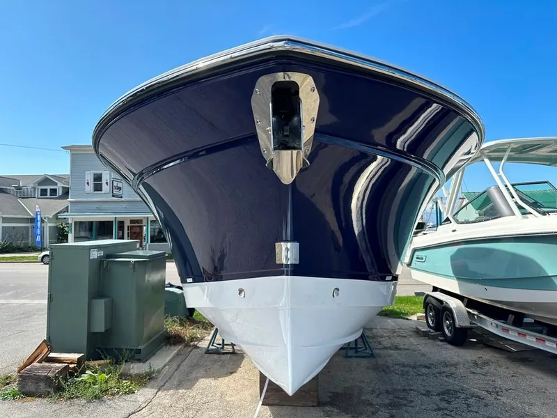 Slide: The Image of 2024 Blackfin 302 DC boat front view in a marina. - 3