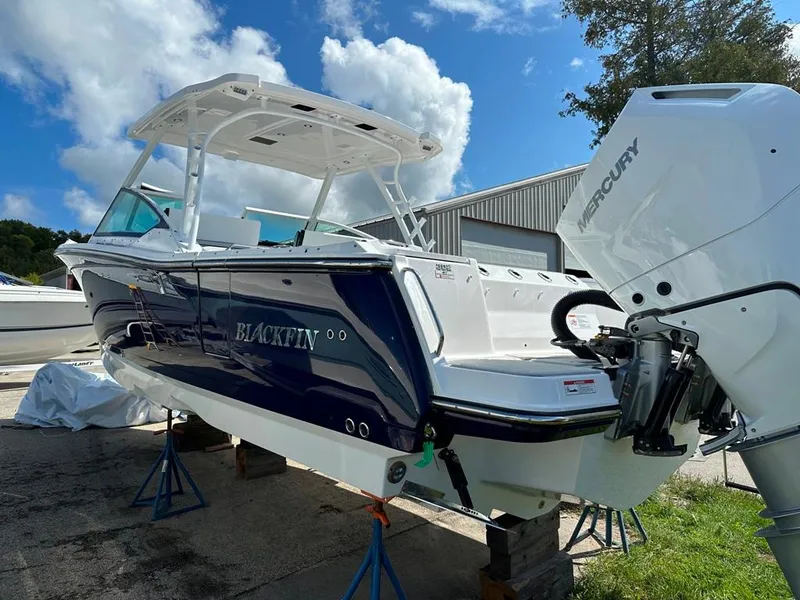 Slide: The Image of 2024 Blackfin 302 DC boat with Mercury outboard motor on display. - 4