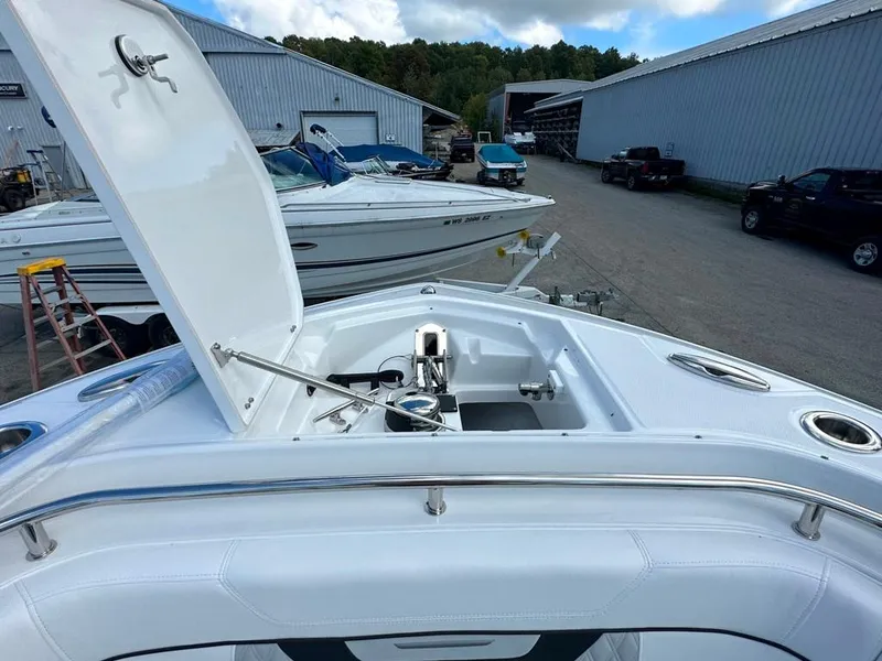 Slide: The Image of 2024 Blackfin 302 DC boat with open storage compartment at marina. - 40