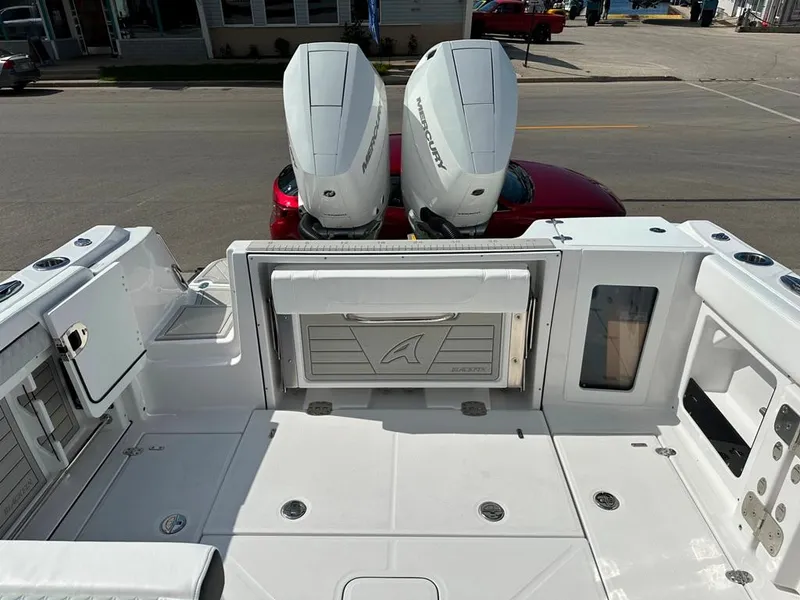 Slide: The Image of 2024 Blackfin 302 DC boat with dual Mercury outboard engines, spacious deck, and storage compartments. - 8