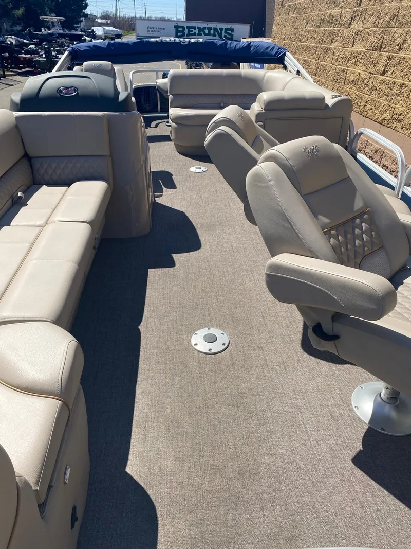 Slide: The Image of 2023 Ranger Reata 220FC boat interior with beige seating and carpeted floor. - 2