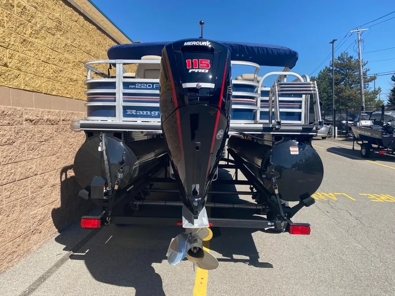 Slide: The Image of 2023 Ranger Reata 220FC pontoon boat with Mercury 115 Pro XS engine, parked outdoors. - 4