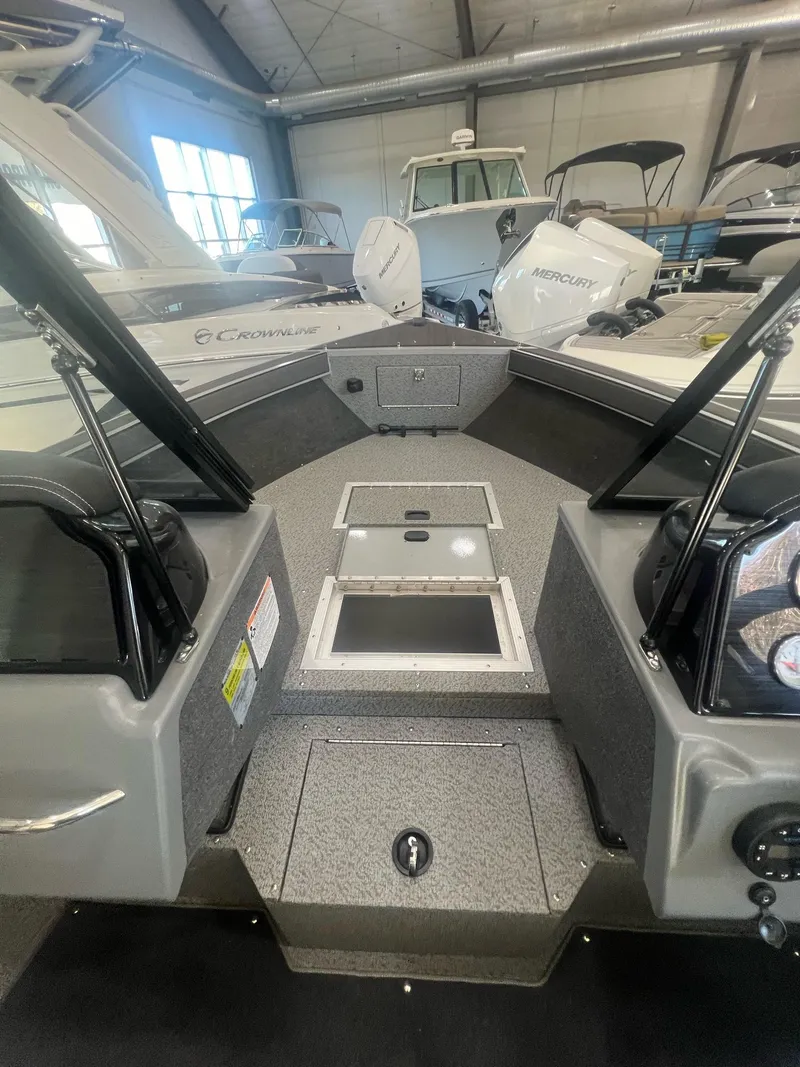 Slide: The Image of 2023 Starcraft Fishmaster 196 boat interior with storage compartments in a showroom. - 4