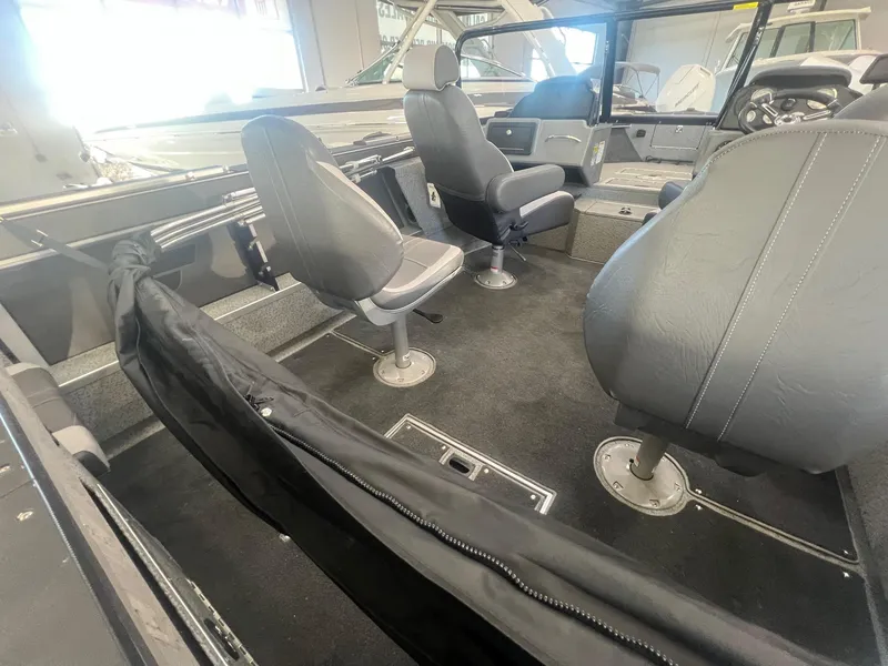 Slide: The Image of 2023 Starcraft Fishmaster 196 boat interior with seating and steering console. - 8