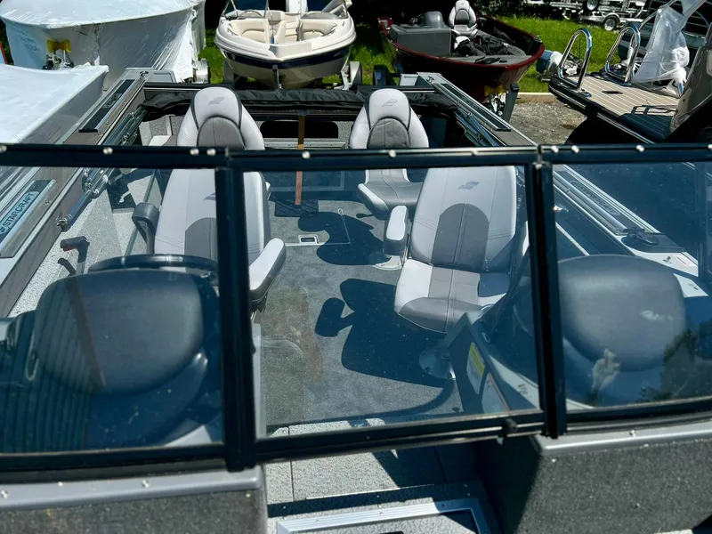 Slide: The Image of 2023 Starcraft Fishmaster 196 interior with seating and windshield view. - 2
