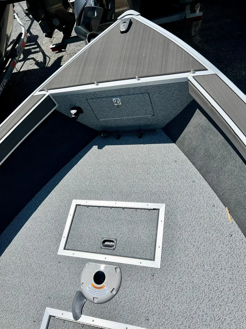 Slide: The Image of 2023 Starcraft Fishmaster 196 boat interior with dashboard and seating area. - 9