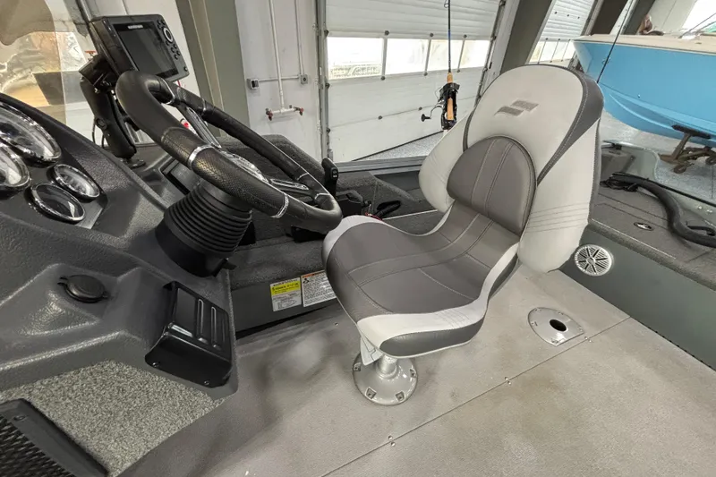 Slide: The Image of 2023 Starcraft Storm 166 SC boat interior with steering wheel and captain's chair. - 11