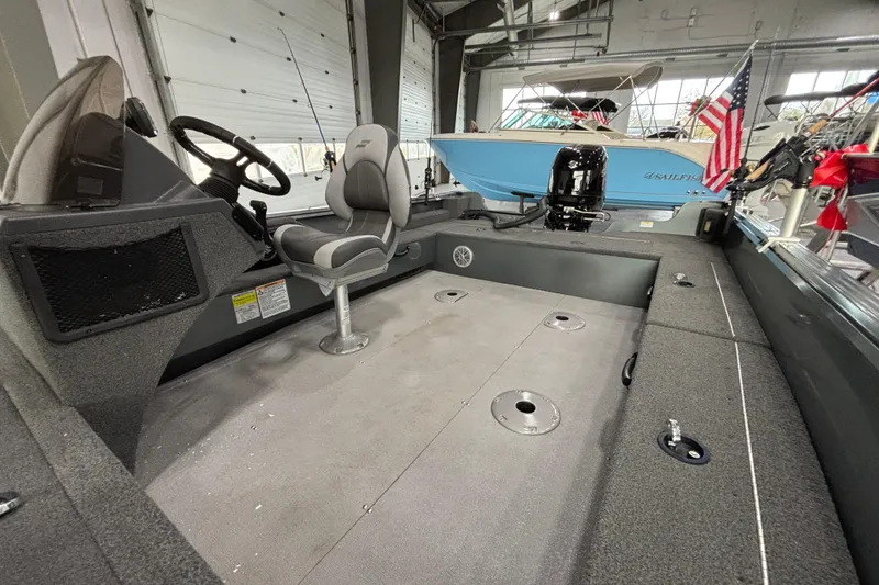 Slide: The Image of 2023 Starcraft Storm 166 SC boat interior with steering console and seating. - 12