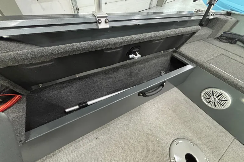 Slide: The Image of 2023 Starcraft Storm 166 SC boat interior storage compartment with speaker and handle. - 14