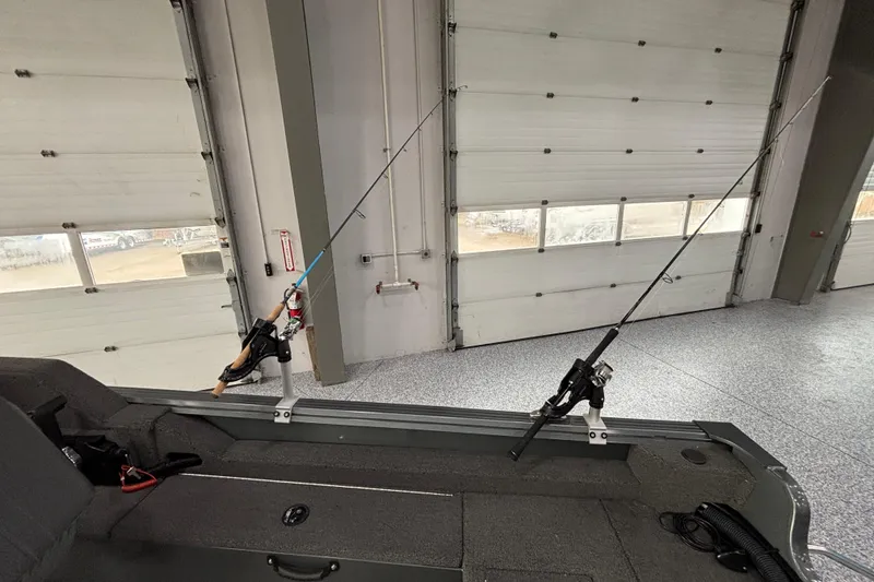 Slide: The Image of 2023 Starcraft Storm 166 SC boat with fishing rods in a garage setting. - 15