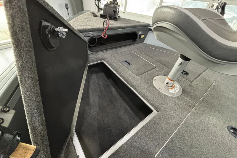 Slide: The Image of 2023 Starcraft Storm 166 SC boat interior with open storage compartment and seat. - 20