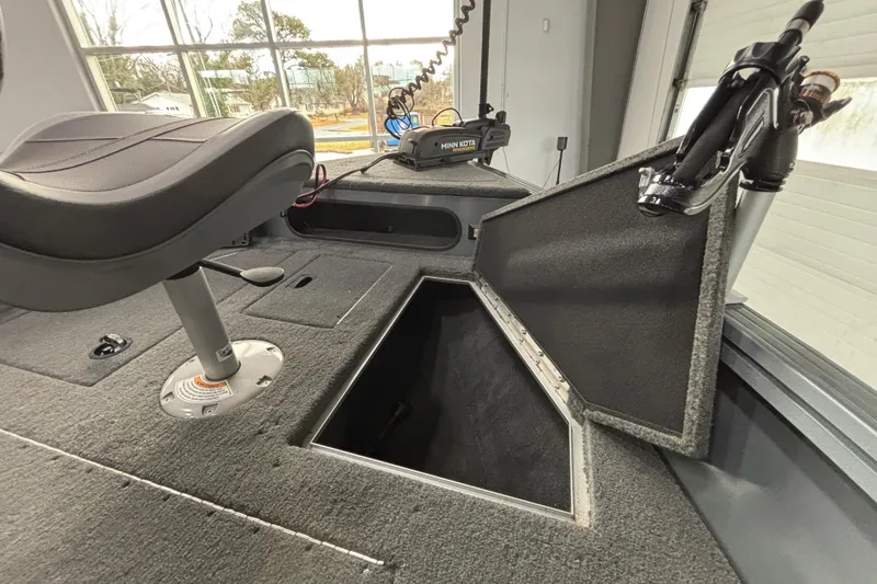 Slide: The Image of 2023 Starcraft Storm 166 SC boat interior with open storage compartment and seat. - 21