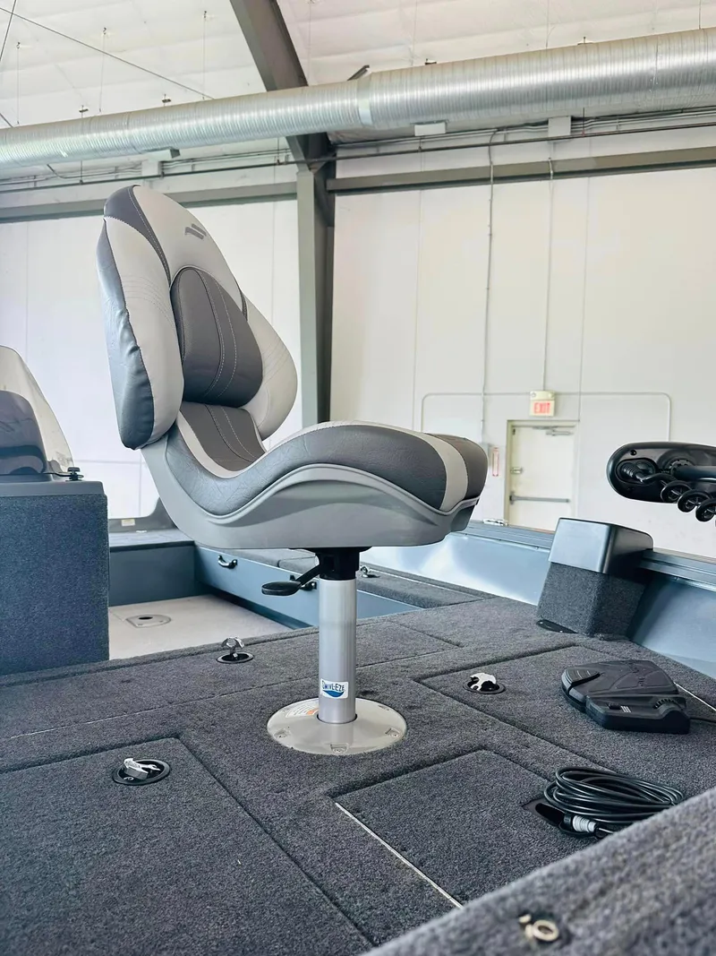 Slide: The Image of 2023 Starcraft Storm 166 SC boat interior with a swivel seat in a showroom. - 28