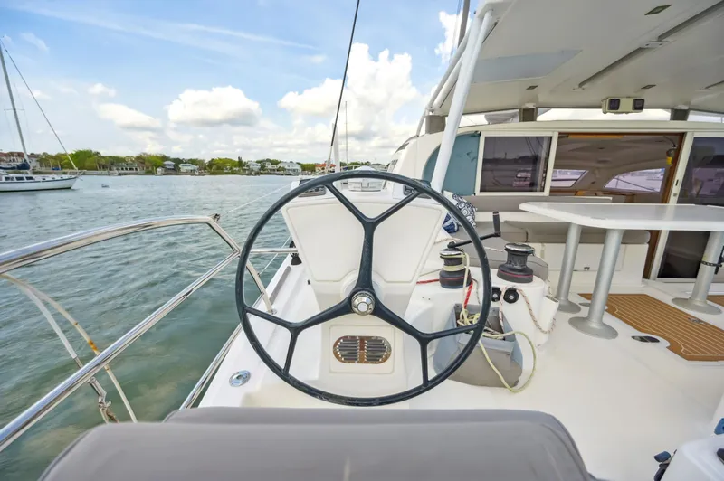 Slide: The Image of Catana 42 yacht cockpit with steering wheel, 2016 model, docked by the water. - 16