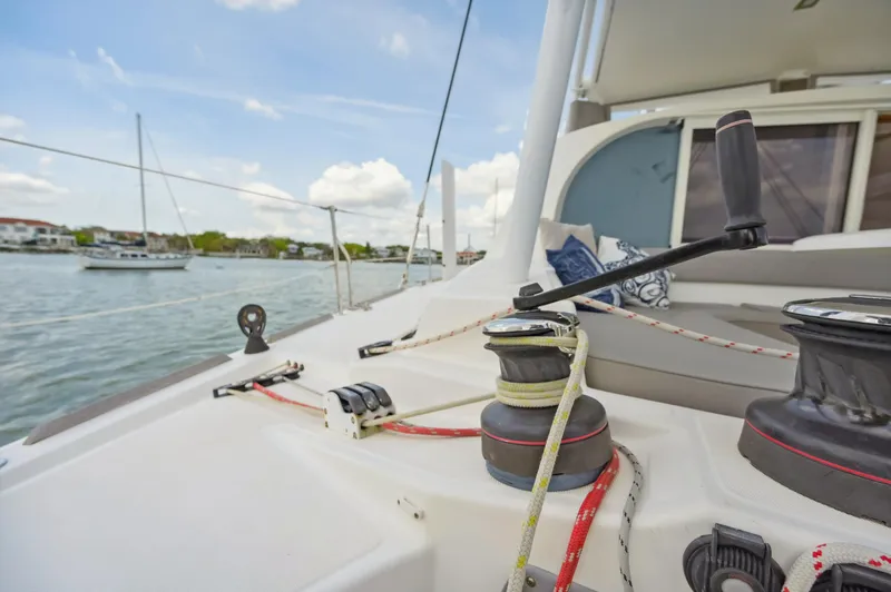 Slide: The Image of Catana 42 sailboat deck view, 2016 model, with winches and ropes, sailing on calm waters. - 17