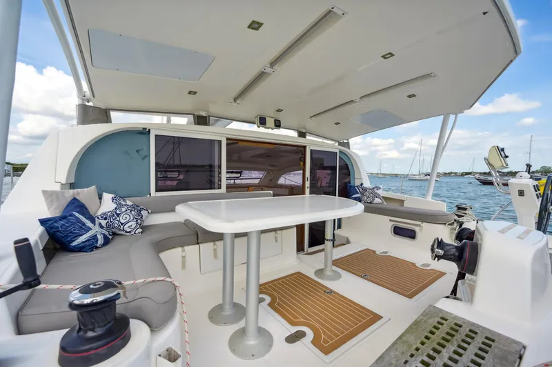 Slide: The Image of Spacious Catana 42 catamaran cockpit with seating, table, and ocean view, 2016 model. - 19