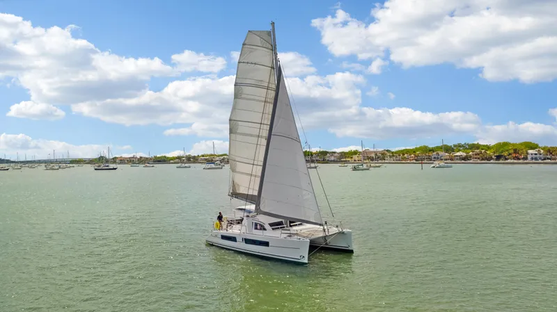 Slide: The Image of 2016 Catana 42 catamaran sailing on a calm, sunny day. - 2
