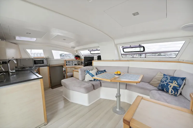 Slide: The Image of Spacious interior of 2016 Catana 42 catamaran with modern kitchen and cozy seating area. - 25