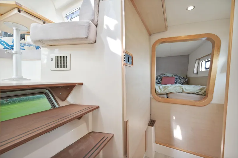 Slide: The Image of Interior of 2016 Catana 42 yacht with cozy cabin and wooden stairs. - 28